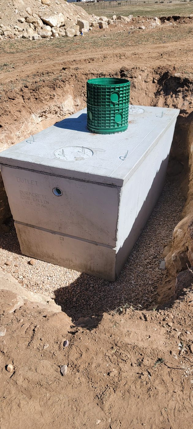 Duracrete 1,500 gallon precast septic tank bedded on gravel with a riser installed, rural Utah