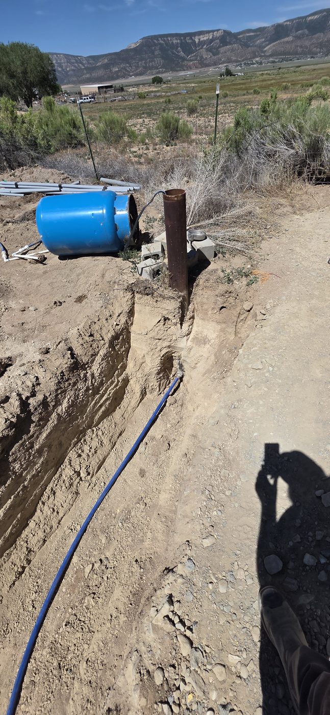Water line connected to the pitless adapter on a well casing, rural Utah