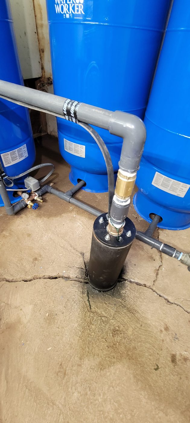 New well pressure tanks and supply lines installed in a rural Utah pump house